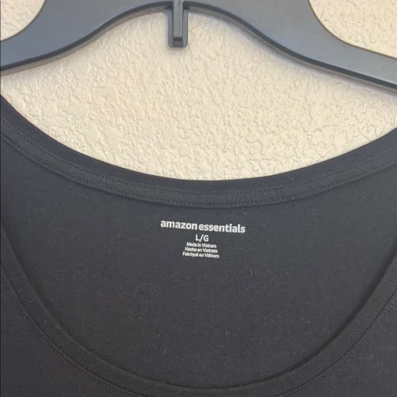 Women large Amazon tops in white and black. One top has a wider neckline. - Picture 10 of 14